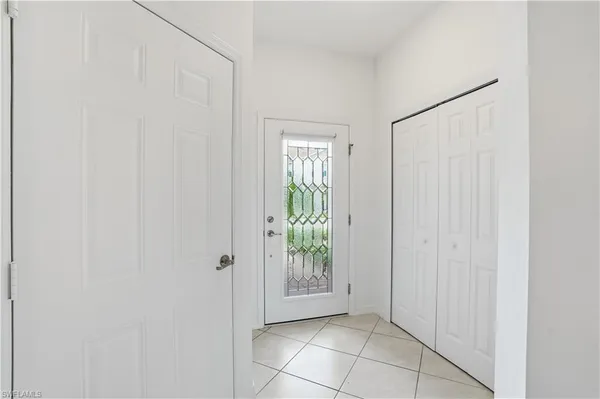 a view of an entryway with wooden floor