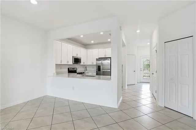 a kitchen with stainless steel appliances a refrigerator and a stove top oven