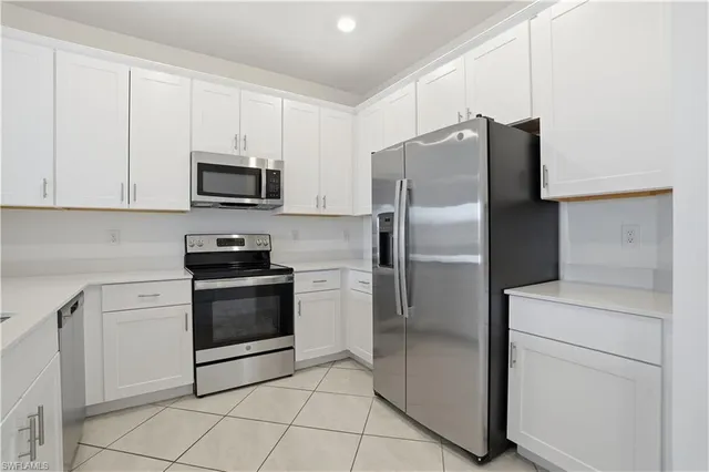 a kitchen with stainless steel appliances a refrigerator sink and microwave