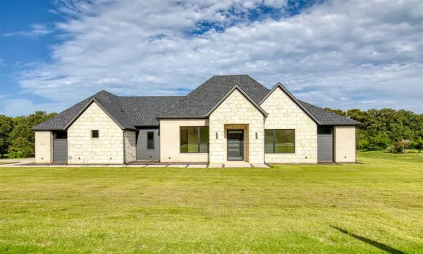 a front view of house with yard and green space