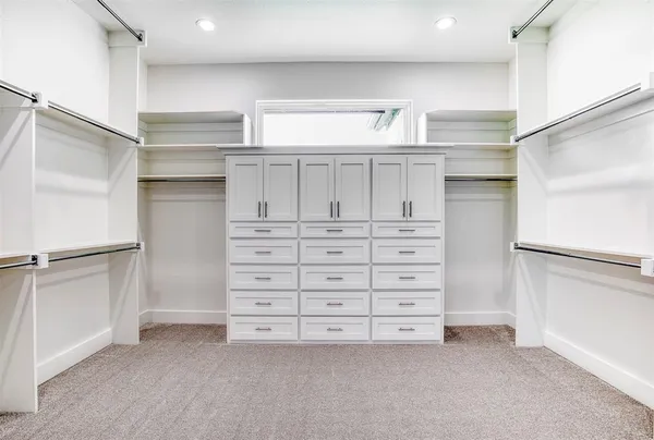 a view of an empty walk in closet with empty racks