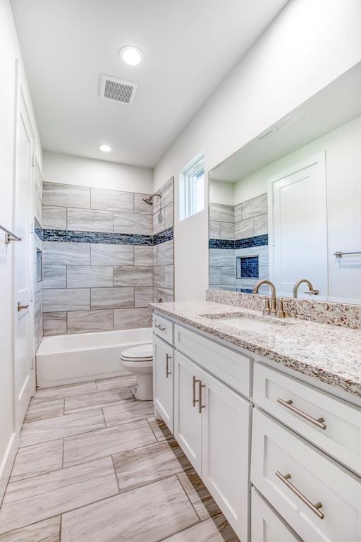 1044 Hidden Oaks Drive Wills Point, TX 75169 - Photo 24 of 29 a bathroom with a granite countertop sink mirror and bathtub