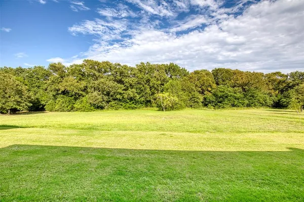 a view of ocean with green space