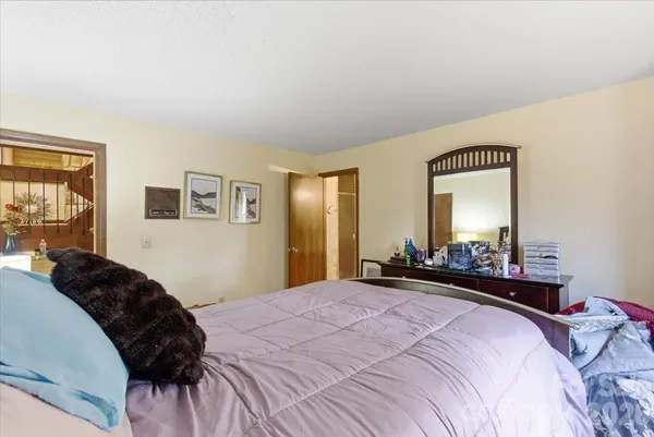 a bedroom with a bed and a lamp with window