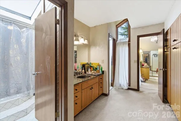 a spacious bathroom with a shower and a sink