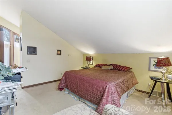 a bedroom with a bed and a potted plant