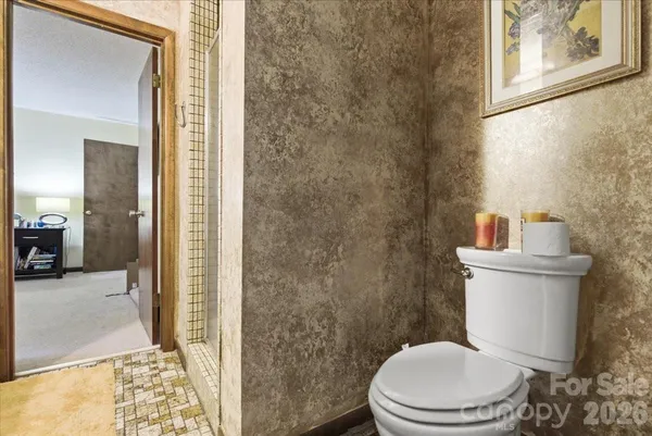a white toilet sitting next to a bathroom sink