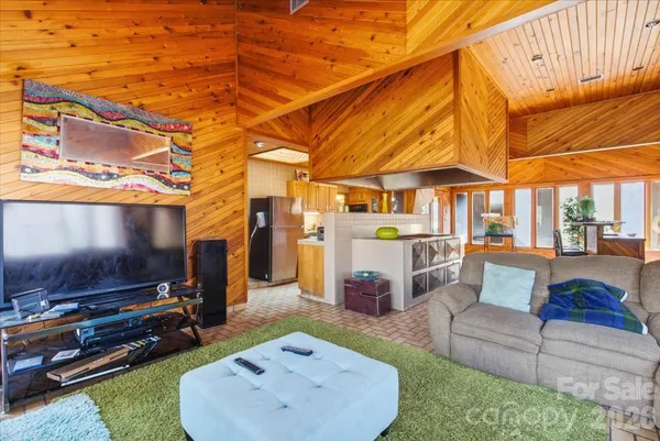 a view of a backyard with furniture and a flat screen tv