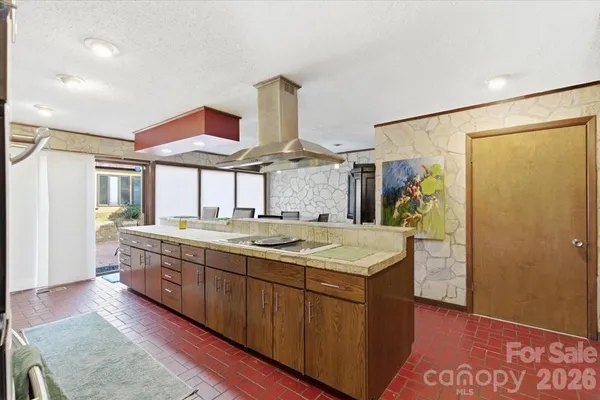 a kitchen with stainless steel appliances granite countertop a sink and a refrigerator
