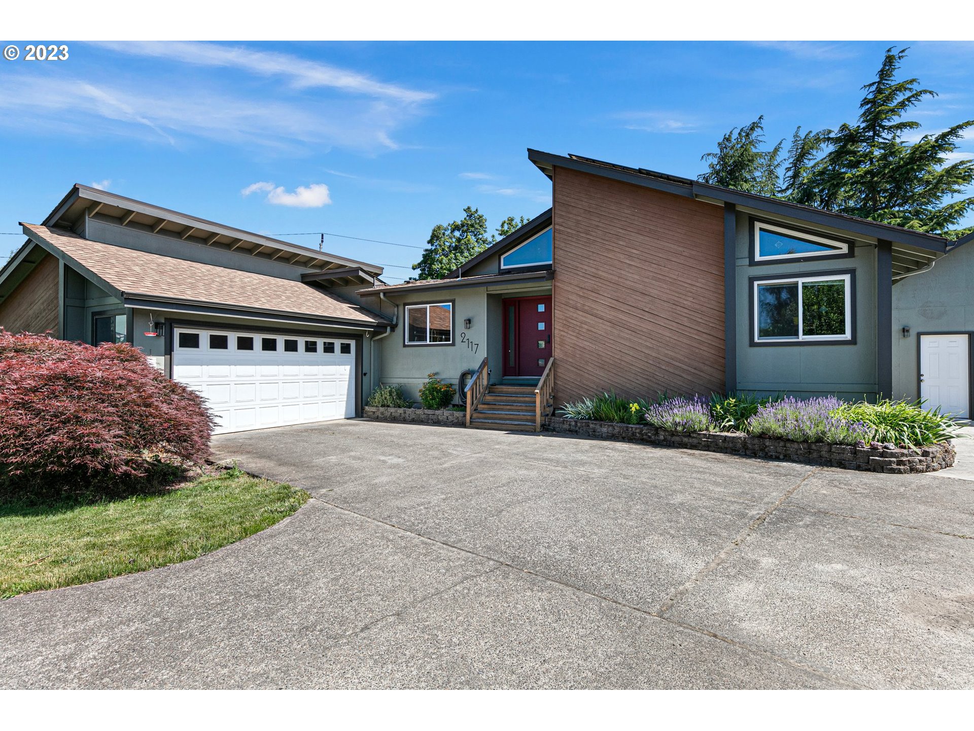 2117 7th Street Springfield, OR 97477 - Photo 3 of 48 a front view of a house with a yard and garage
