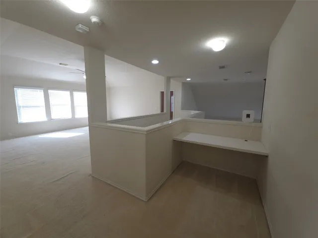 an empty room with a empty space and a ceiling fan