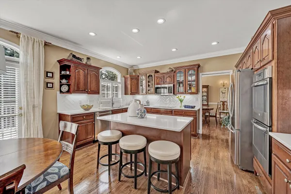 a view of a house with a big yard and a car parked on the road
