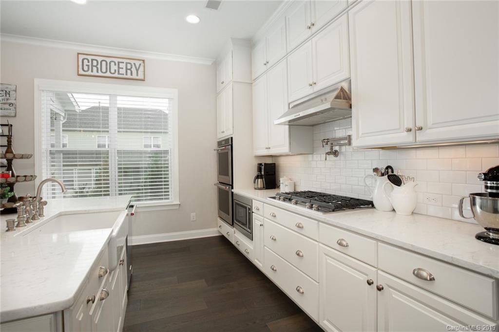 5231 Meadowcroft Way Fort Mill, SC 29708 - Photo 11 of 40 a kitchen with stainless steel appliances white cabinets and a stove