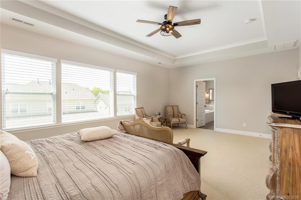 5231 Meadowcroft Way Fort Mill, SC 29708 - Photo 18 of 40 a bedroom with a bed a large window and a flat screen tv