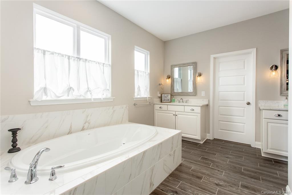 5231 Meadowcroft Way Fort Mill, SC 29708 - Photo 19 of 40 a bathroom with a tub sink and window