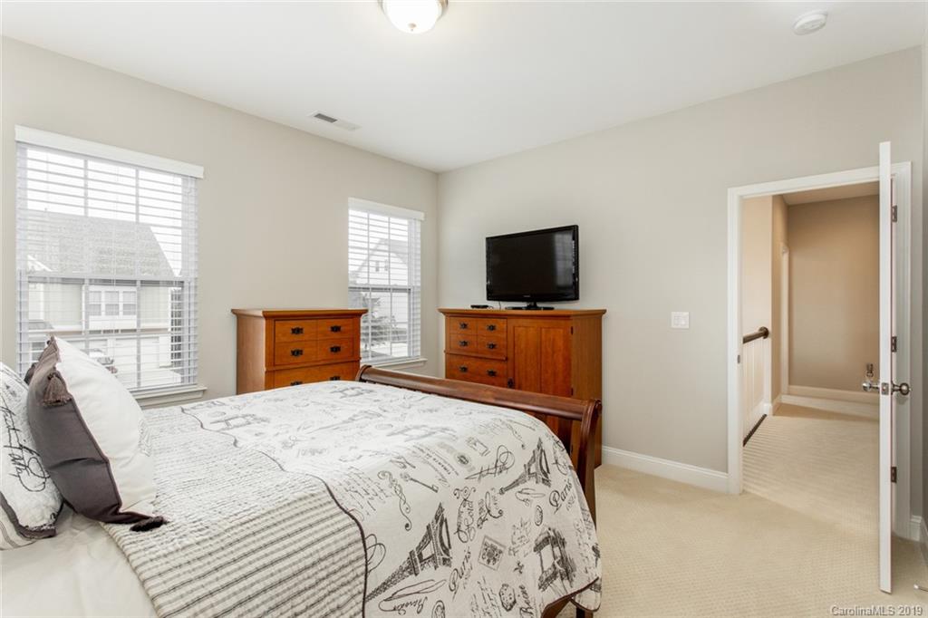 5231 Meadowcroft Way Fort Mill, SC 29708 - Photo 23 of 40 a bedroom with a bed and a flat screen tv