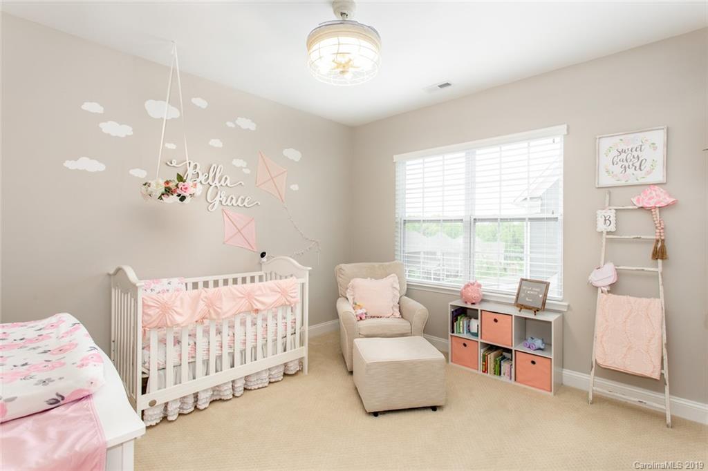 5231 Meadowcroft Way Fort Mill, SC 29708 - Photo 27 of 40 a bedroom with furniture and a chandelier