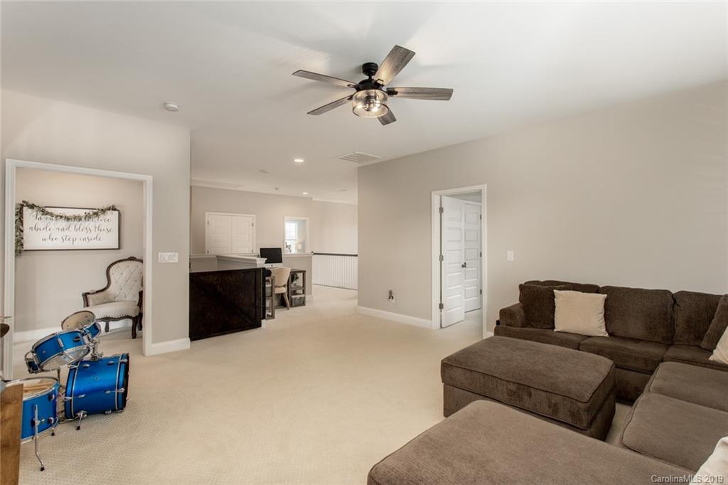 5231 Meadowcroft Way Fort Mill, SC 29708 - Photo 34 of 40 a living room with furniture and a chandelier