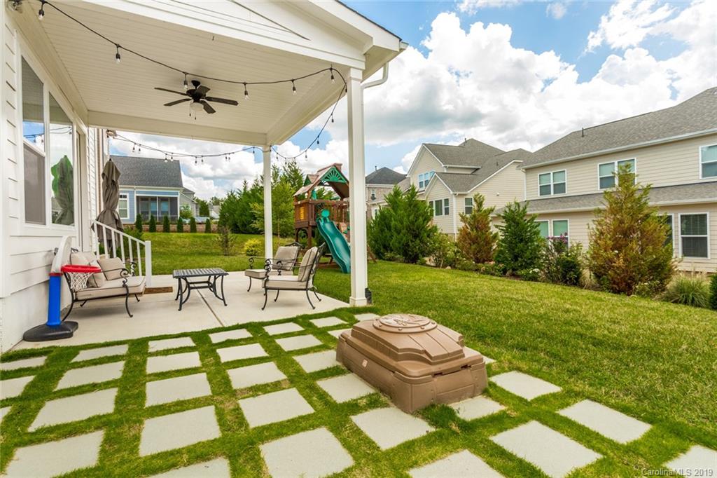 5231 Meadowcroft Way Fort Mill, SC 29708 - Photo 39 of 40 a view of a patio with table and chairs potted plants and palm trees