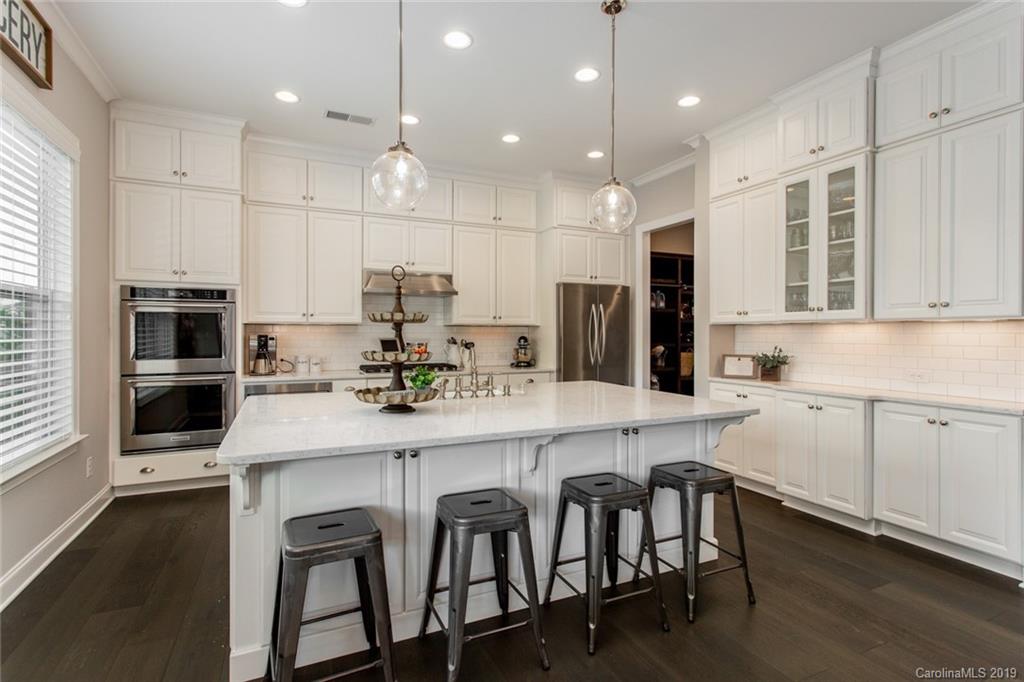 5231 Meadowcroft Way Fort Mill, SC 29708 - Photo 10 of 40 a kitchen with kitchen island cabinets and chairs