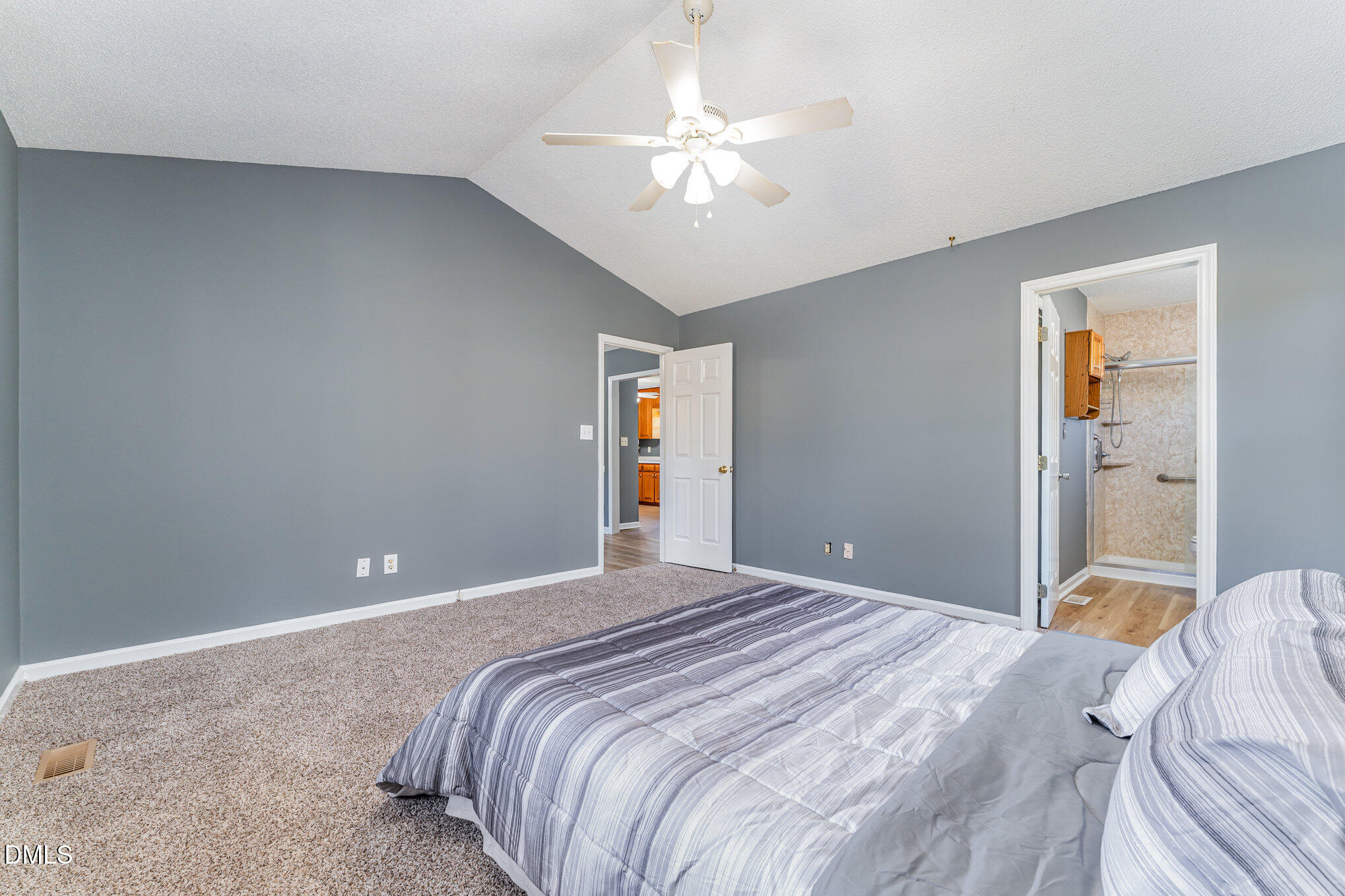 6408 Glen Brack Court Raleigh, NC 27603 - Photo 11 of 23 a bedroom with a large bed and a chandelier
