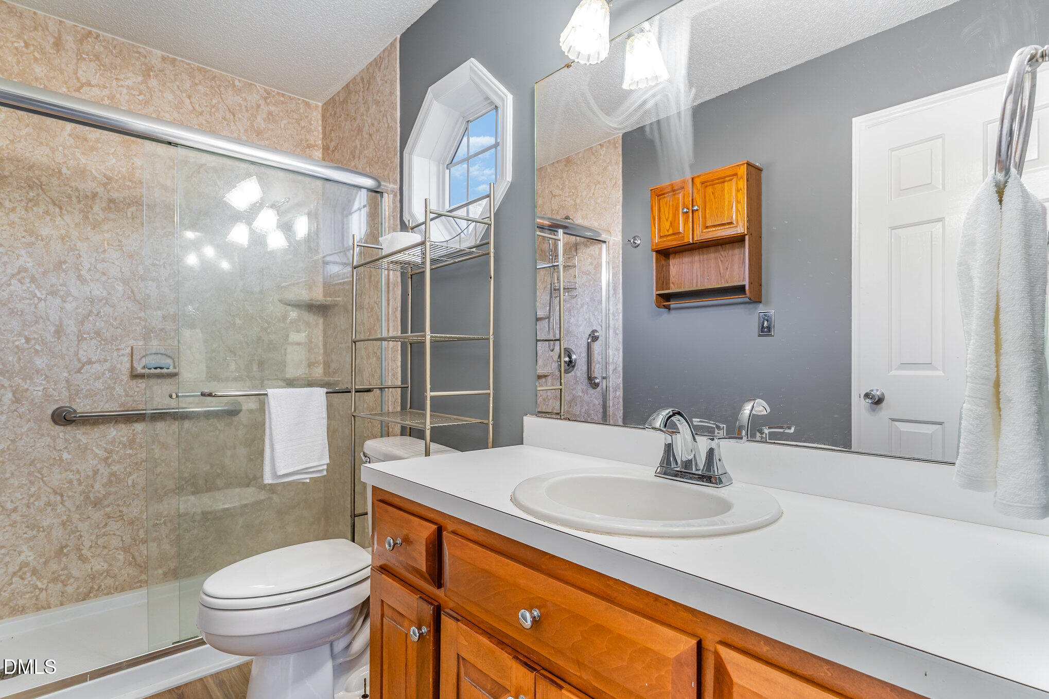 6408 Glen Brack Court Raleigh, NC 27603 - Photo 12 of 23 a bathroom with a sink and a mirror