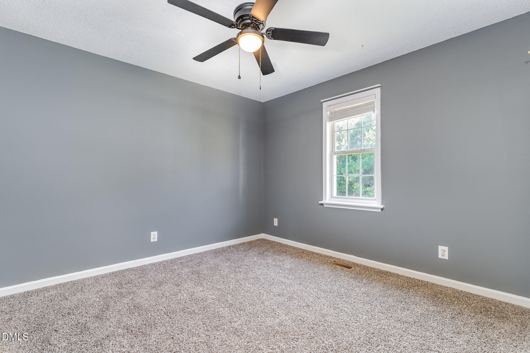6408 Glen Brack Court Raleigh, NC 27603 - Photo 13 of 23 an empty room with a window and a fan