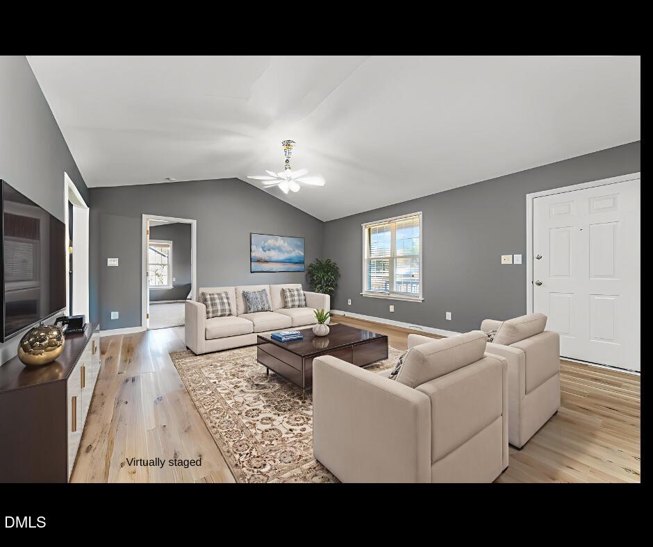6408 Glen Brack Court Raleigh, NC 27603 - Photo 2 of 23 a living room with furniture and a flat screen tv