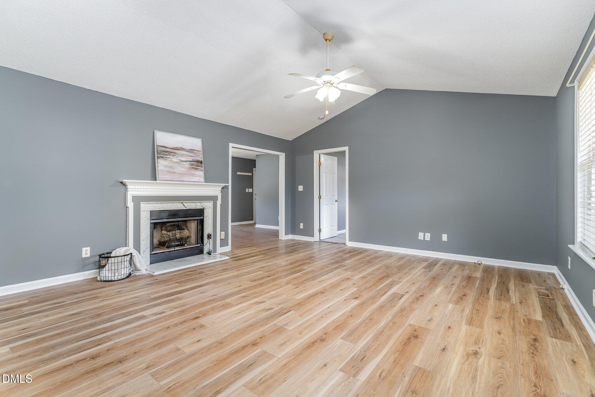 6408 Glen Brack Court Raleigh, NC 27603 - Photo 5 of 23 a view of empty room with wooden floor and fireplace