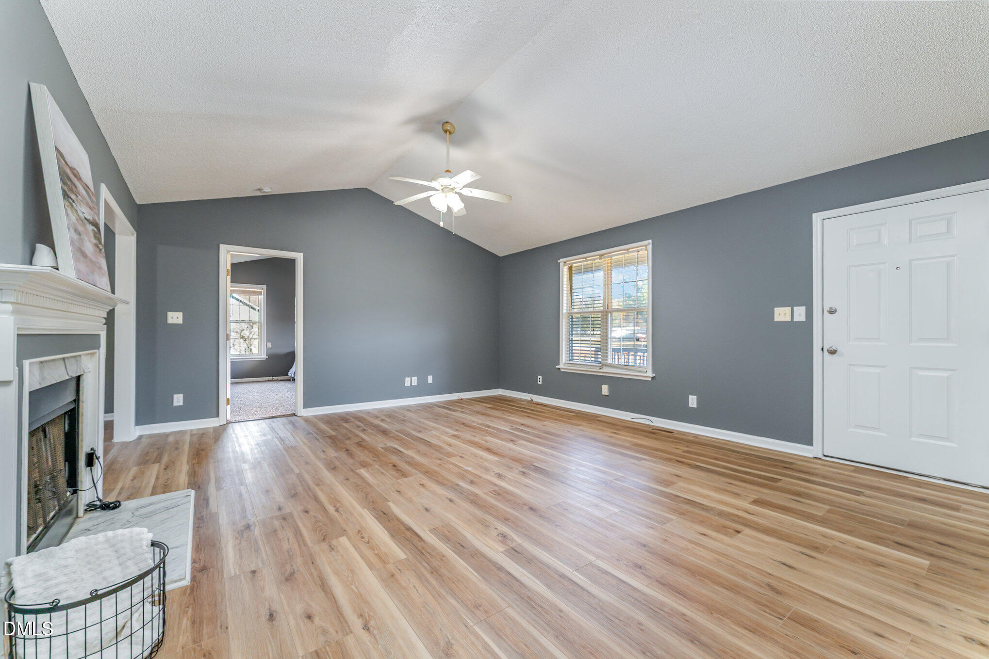 6408 Glen Brack Court Raleigh, NC 27603 - Photo 6 of 23 a view of an empty room with window and wooden floor
