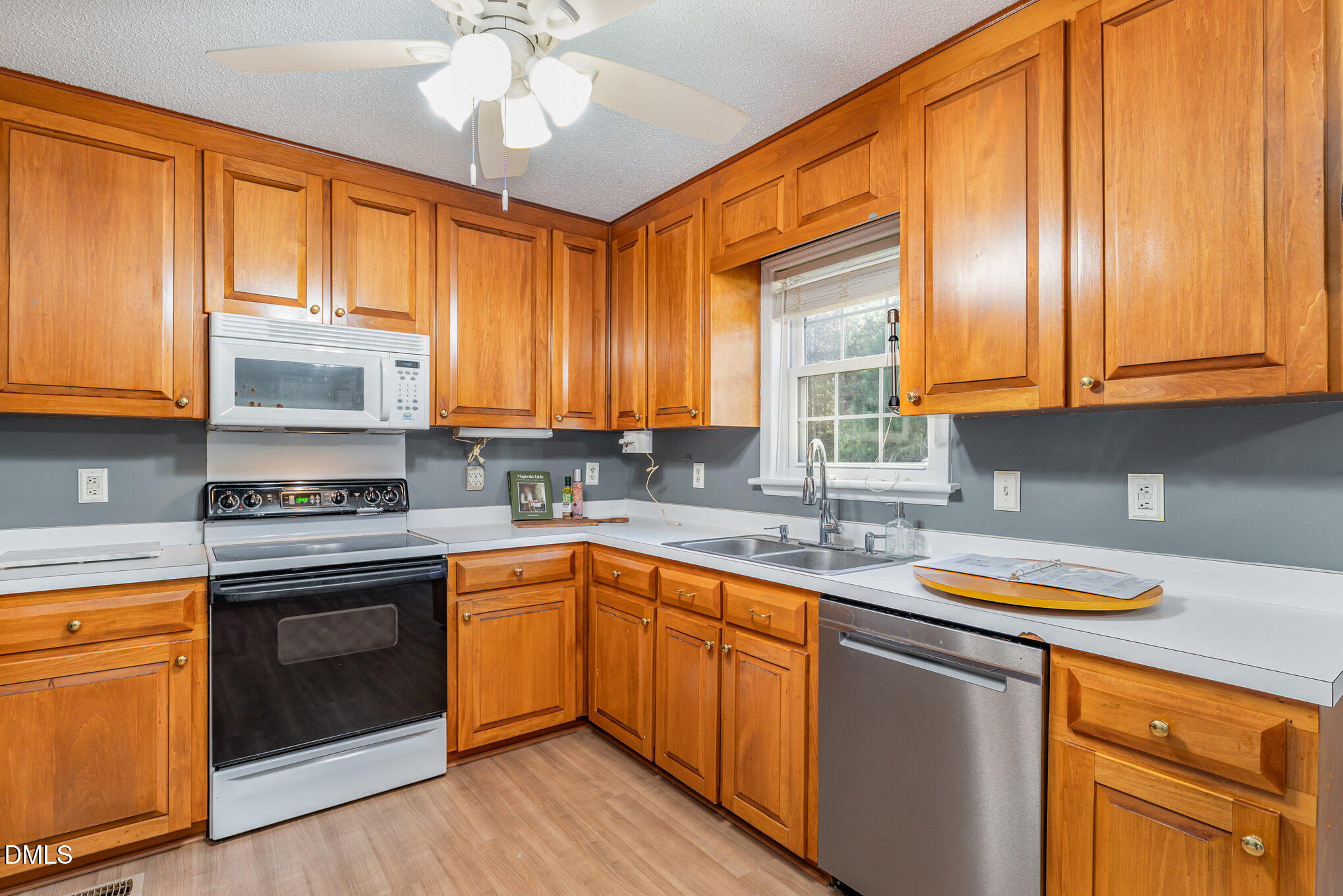 6408 Glen Brack Court Raleigh, NC 27603 - Photo 8 of 23 a kitchen with stainless steel appliances granite countertop a sink a stove cabinets and wooden floor