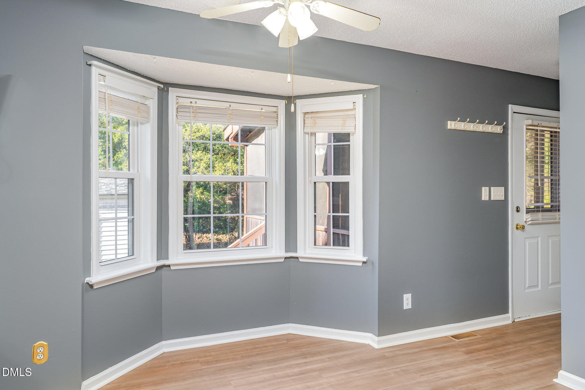 6408 Glen Brack Court Raleigh, NC 27603 - Photo 9 of 23 a view of an empty room with wooden floor and a window