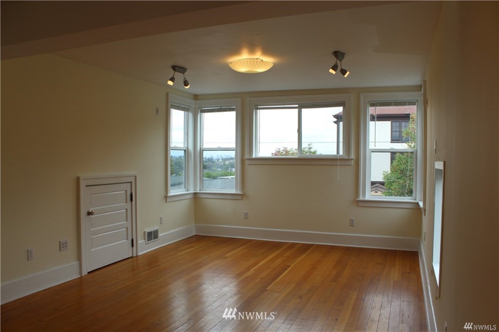 2515 16th Avenue South Seattle, WA 98144 - Photo 11 of 18 an empty room with a window and wooden floor