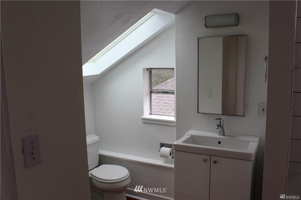 2515 16th Avenue South Seattle, WA 98144 - Photo 15 of 18 a bathroom with a sink toilet and vanity