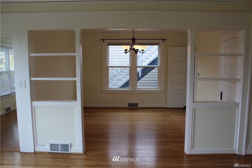 2515 16th Avenue South Seattle, WA 98144 - Photo 7 of 18 an empty room with wooden floor and windows