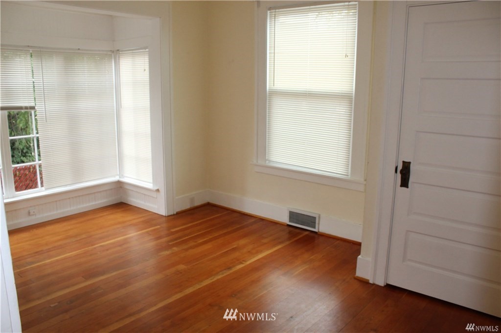 2515 16th Avenue South Seattle, WA 98144 - Photo 8 of 18 an empty room with wooden floor and windows