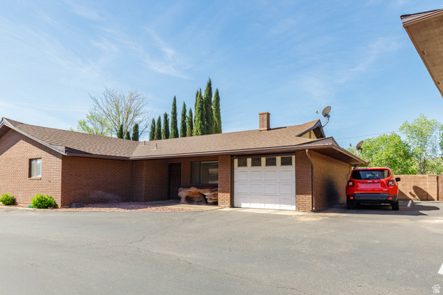 3707 Gates Circle Santa Clara, UT 84765 - Photo 1 of 19 View of front of home with brick siding, a chimney, an attached garage, and roof with shingles