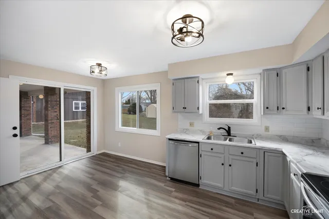 a kitchen with a sink cabinets and window