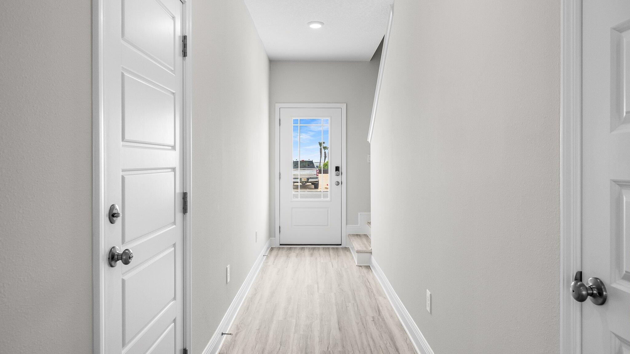 53 Hatton Court Santa Rosa Beach, FL 32459 - Photo 11 of 14 a view of a hallway with wooden floor and a bathroom