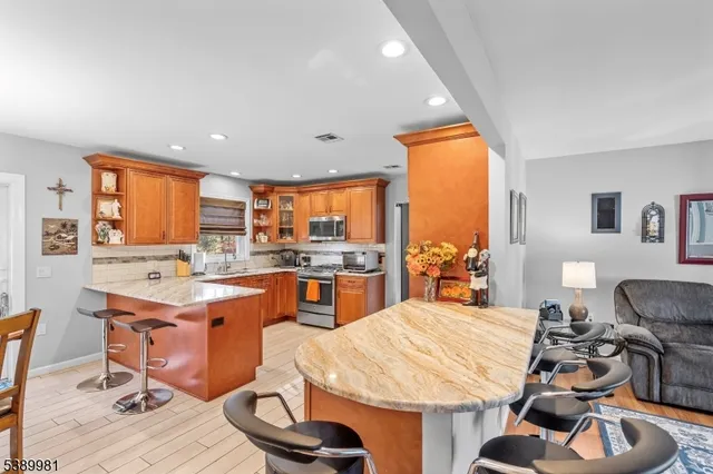 a room with wooden floor pool table and chairs