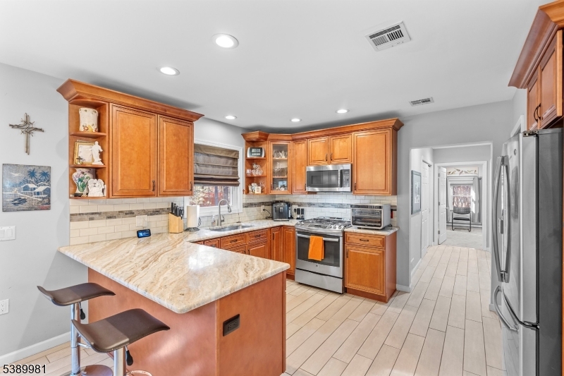 379 East Bird Village Road Jackson, NJ 08527 - Photo 12 of 38 a kitchen with stainless steel appliances granite countertop a sink stove and refrigerator