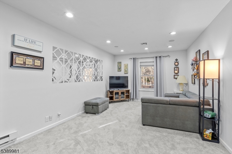 379 East Bird Village Road Jackson, NJ 08527 - Photo 15 of 38 a living room with furniture and a flat screen tv