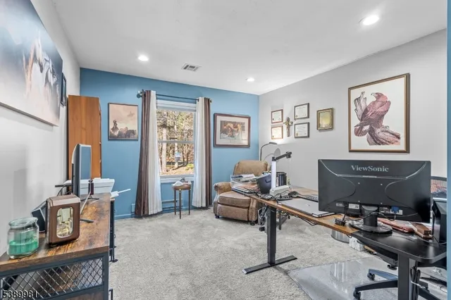 a living room with furniture a window and a flat screen tv
