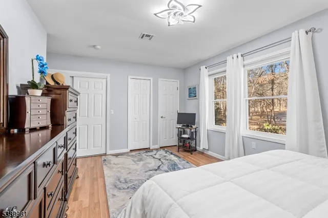 a bedroom with a bed dresser and a window