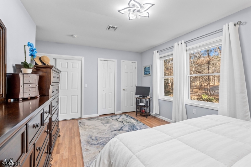 379 East Bird Village Road Jackson, NJ 08527 - Photo 20 of 38 a bedroom with a bed dresser and a window