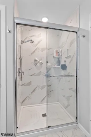 a bathroom with a glass shower door