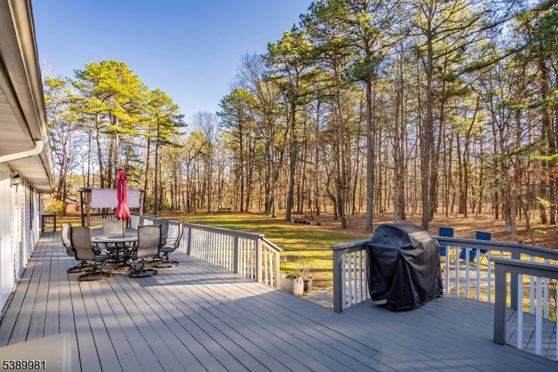 379 East Bird Village Road Jackson, NJ 08527 - Photo 36 of 38 a view of a chairs and table on the wooden deck