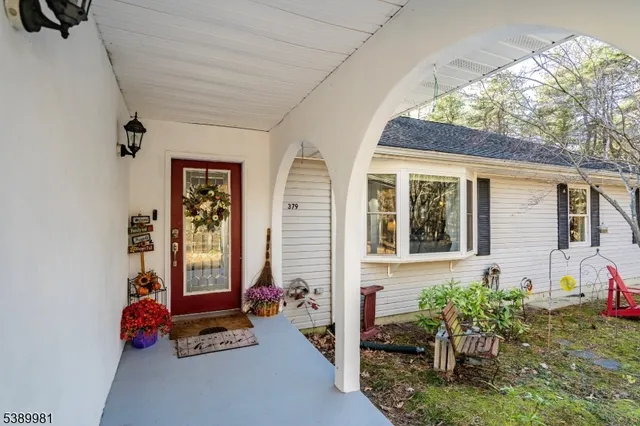 a front view of a house with outdoor seating