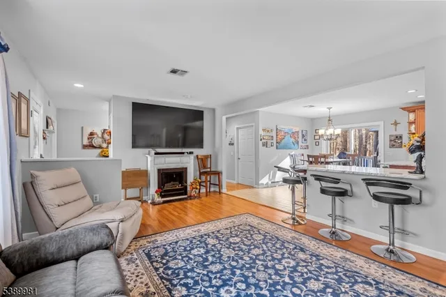 a living room with furniture a rug and a flat screen tv