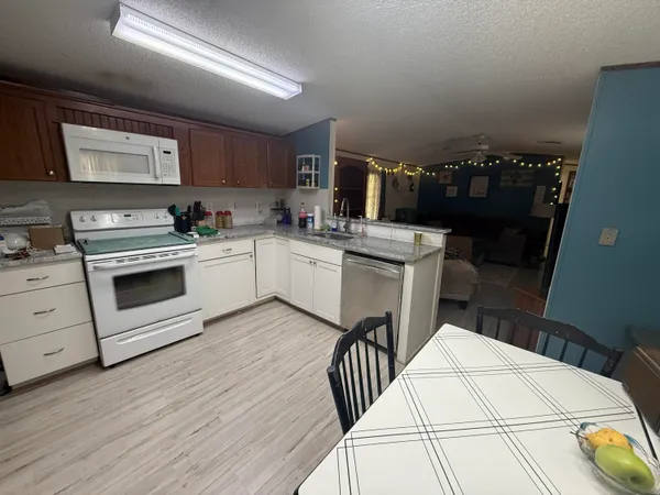 a kitchen with a stove a sink and a refrigerator